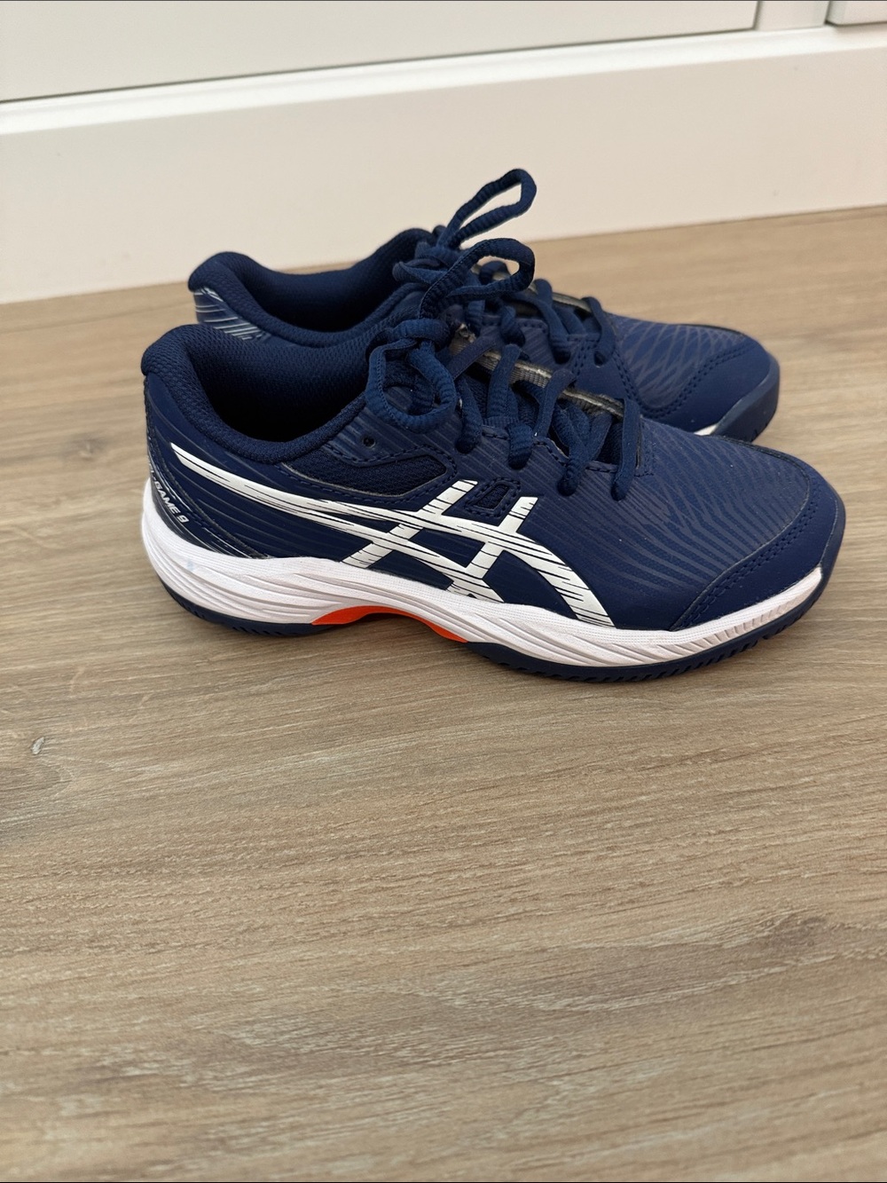 Asics Kids Navy and White Court Sneakers with Orange Accent